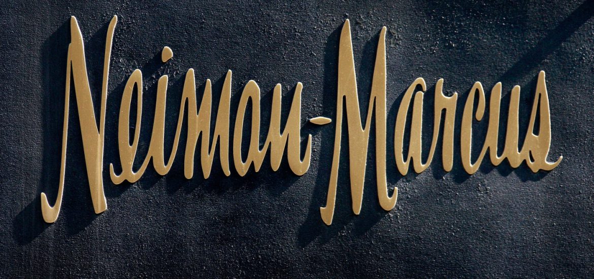 CHICAGO - MARCH 05: A bronze logo hangs on the side of a Neiman Marcus store on the Magnificent Mile March 5, 2009 in Chicago, Illinois. Neiman Marcus Group Inc., which operates Neiman Marcus, recently reported a 24 percent decline in sales. (Photo by Scott Olson/Getty Images)